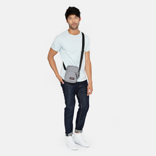 The One Sunday Grey Crossbody Bag Over Shoulder Of Male Model