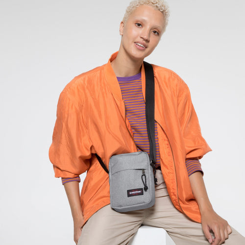 The One Sunday Grey Crossbody Bag Over Shoulder Of Female Model