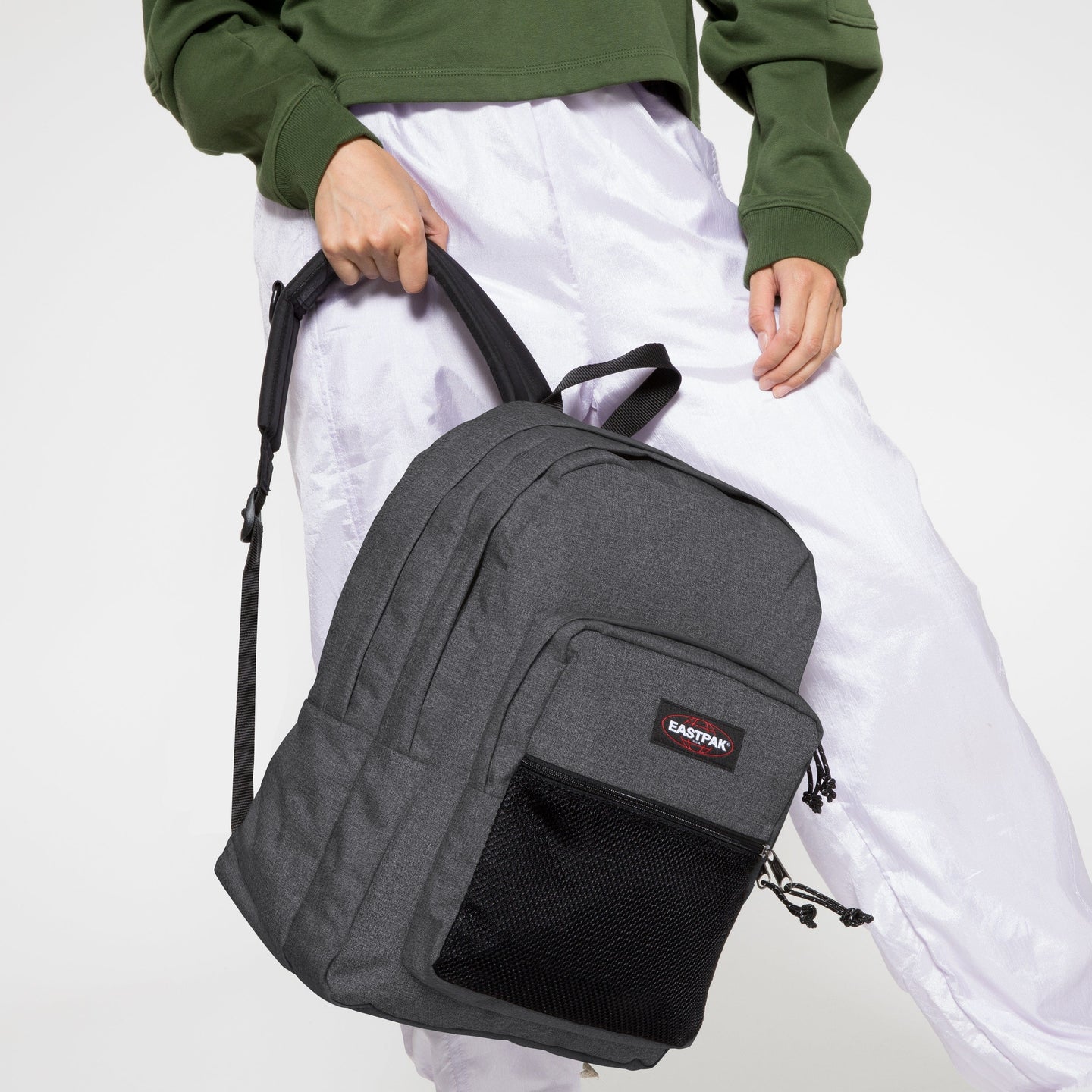 Pinnal Black Denim Backpack with Model Holding the Bag