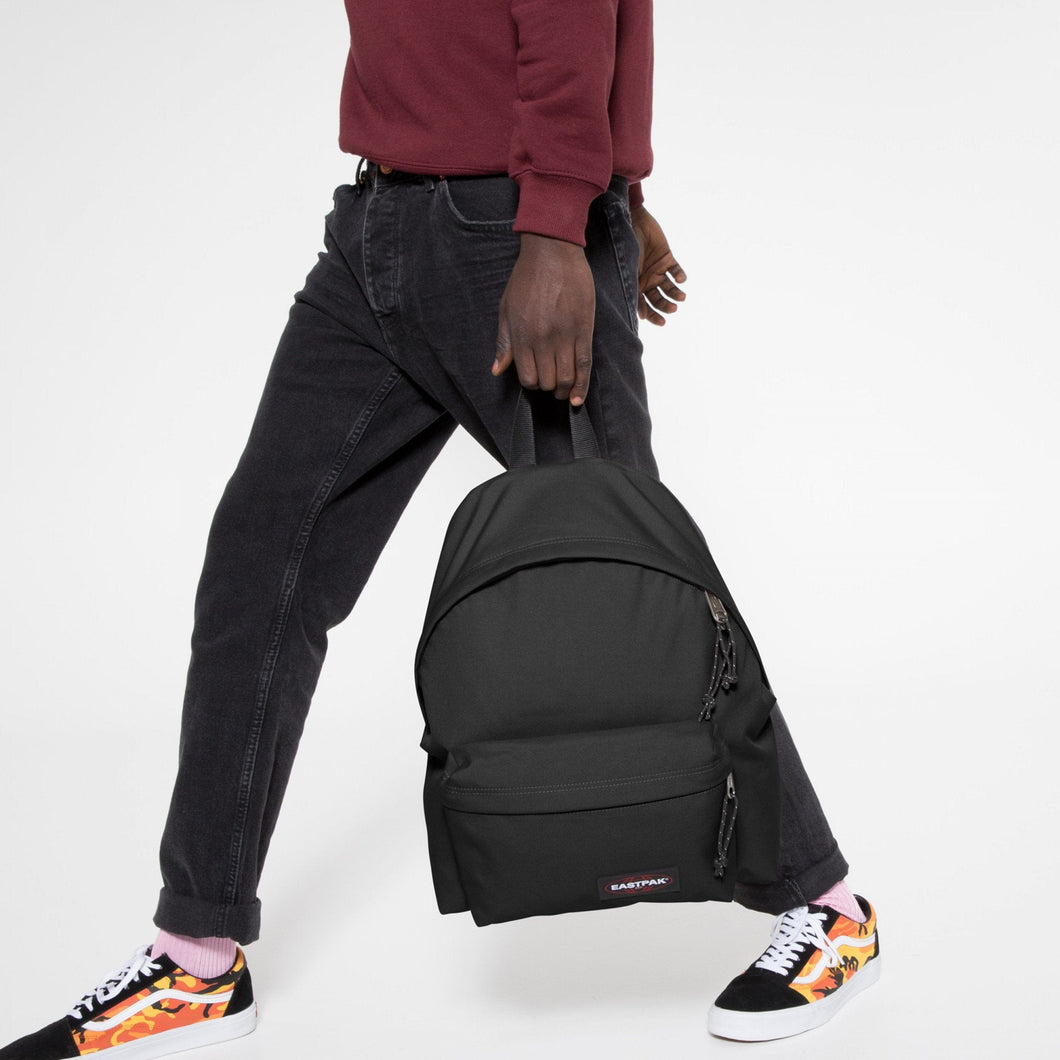 Padded Pak'r Black Backpack With Model Walking And Holding Bag