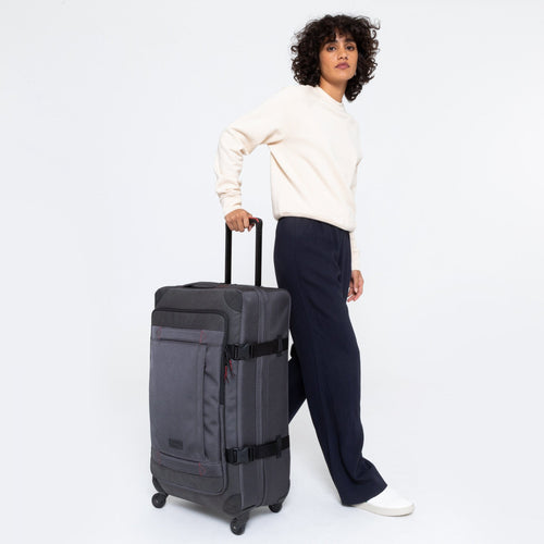 Trans4 Cnnct L Accent Grey Roller Luggage Side View With Model Walking