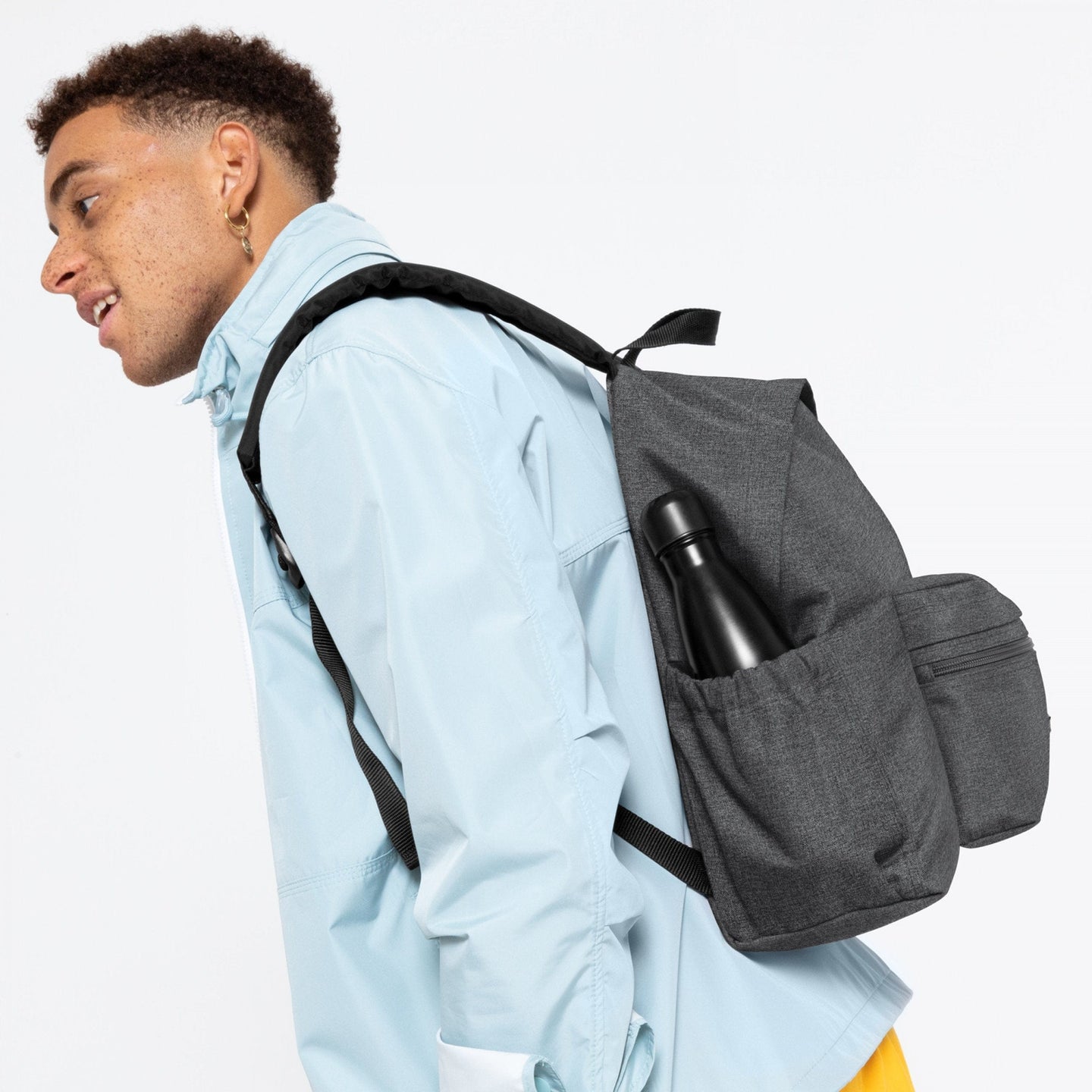 man wearing Padded Zippl'r + Black Denim Backpack