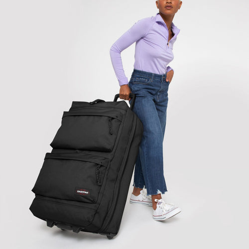 person using Double Tranverz L Black suitcase